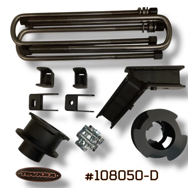 Product photo of Truxxx kit #108050-D for the 2024–2026 Ford F-450 and F-550 (DRW/Dually). The image showcases 2.5-inch front coil spacers and 2.5-inch precision-fabricated rear lift blocks. All components are manufactured from heavy-gauge USA Mill Certified Steel with a durable salt-resistant coat. Includes four high-strength custom U-bolts, heavy-duty shock brackets, and Grade 10.9/12.9 high-tensile fasteners.